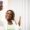 Smiling young adult african woman taking selfie with a mobile outdoors